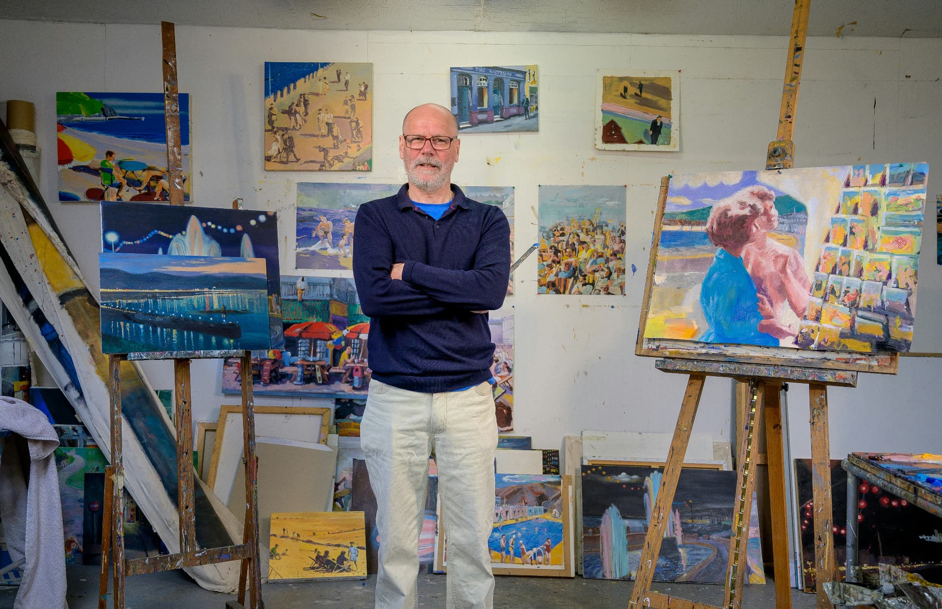 An artist among his canvases in a community studio