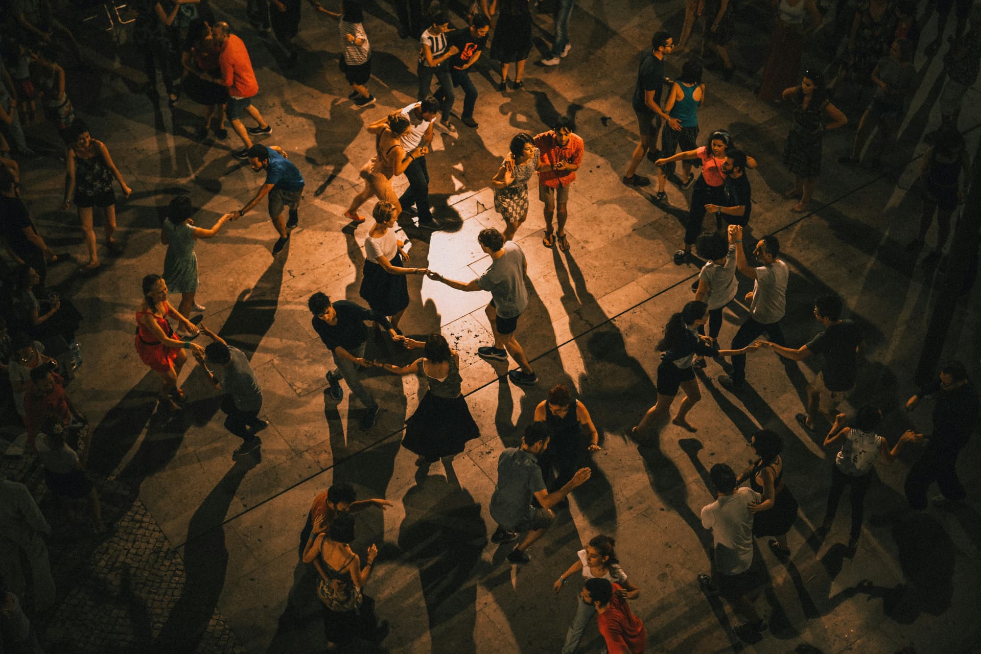 An intergenerational drumming circle held inside a gallery of paintings